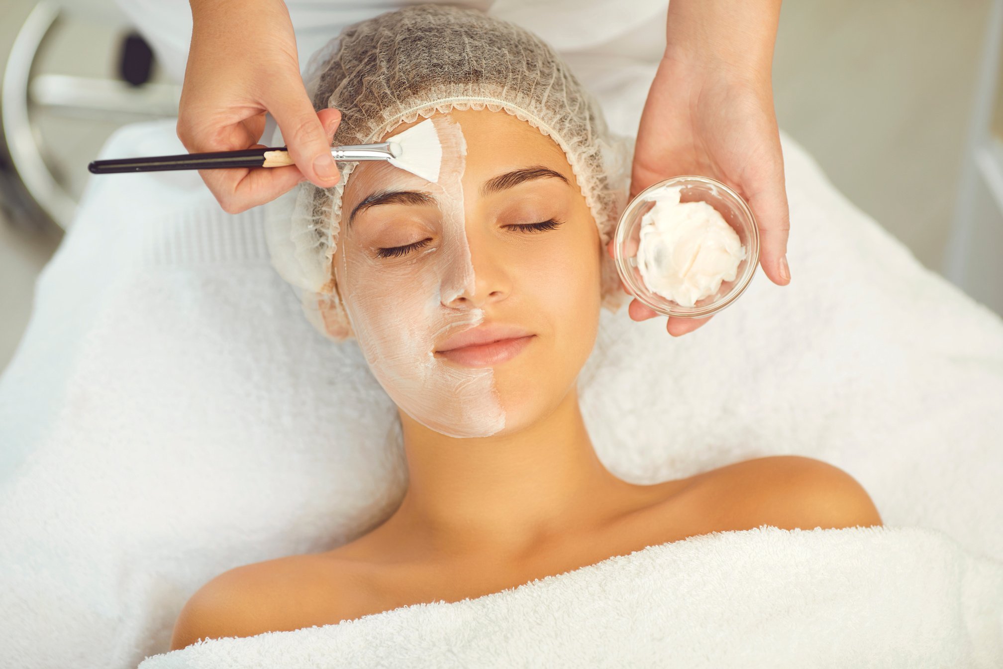 Dermatologist Putting Moisturizing Mask to Womans Face during Skincare Procedure